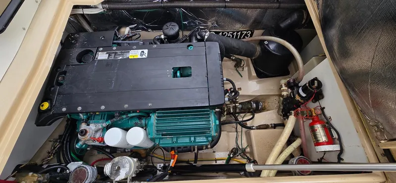 Slide: The Image of Engine compartment of a 2013 Cutwater C-28 boat, showcasing mechanical components and fire extinguisher. - 29