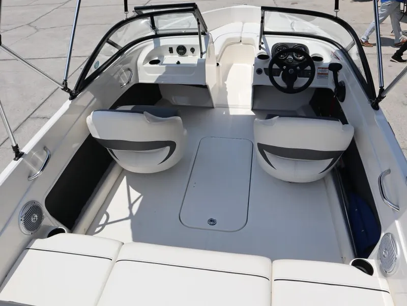 Slide: The Image of 2022 Bayliner 170 BR boat interior with seating and steering wheel. - 12