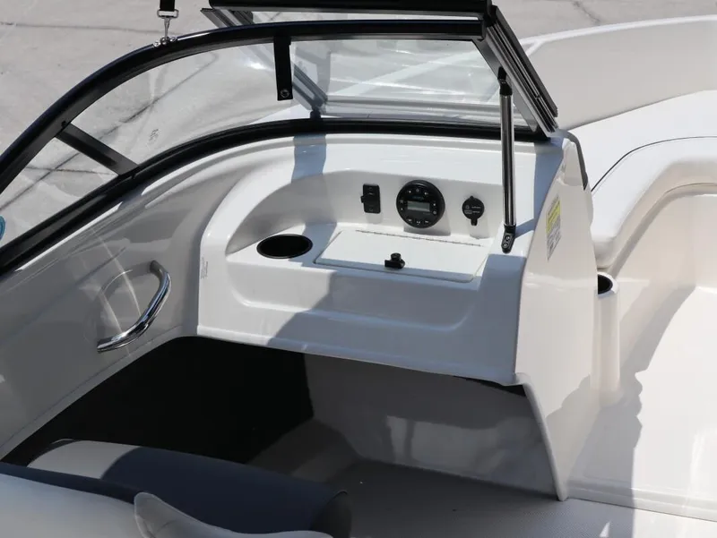 Slide: The Image of 2022 Bayliner 170 BR boat interior with dashboard and seating area. - 13