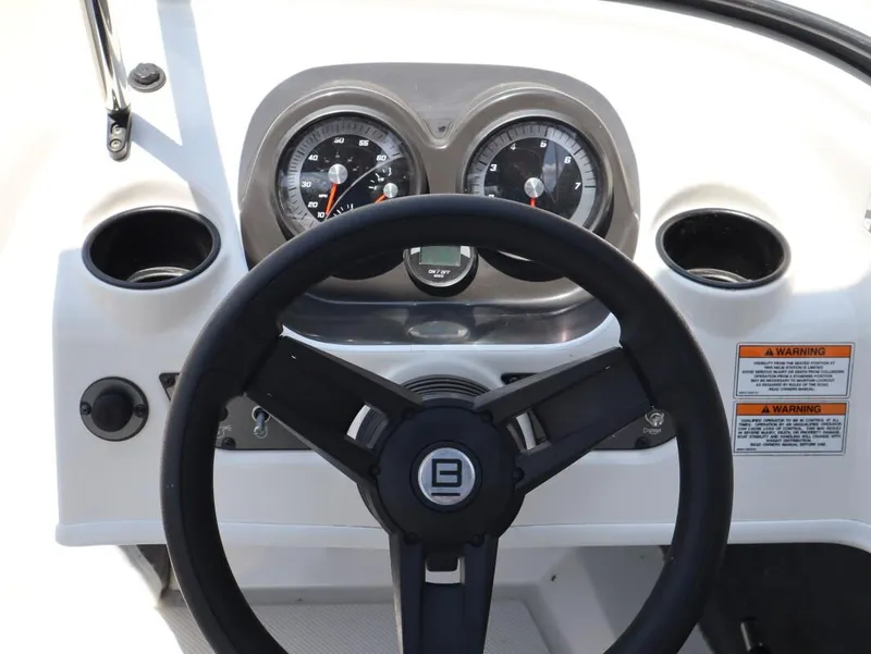 Slide: The Image of Bayliner 170 BR 2022 dashboard with steering wheel and gauges. - 14