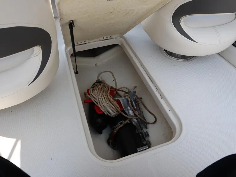 Slide: The Image of Open storage compartment in 2022 Bayliner 170 BR boat with rope and anchor inside. - 15