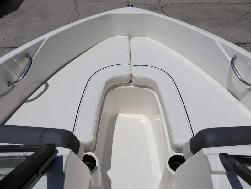 Slide: The Image of 2022 Bayliner 170 BR boat interior with white seating and cup holders. - 17
