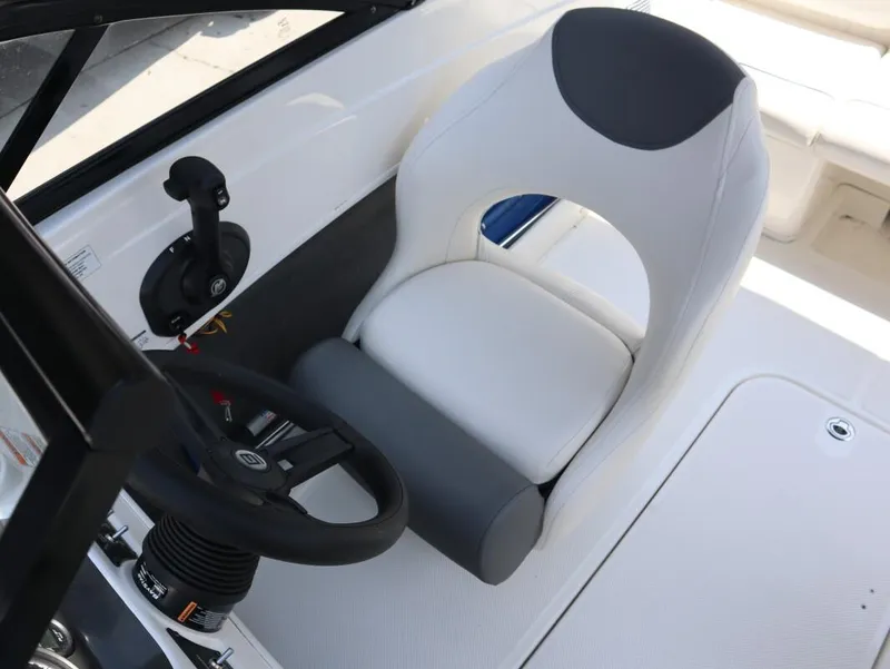 Slide: The Image of 2022 Bayliner 170 BR boat interior with steering wheel and white seat. - 18