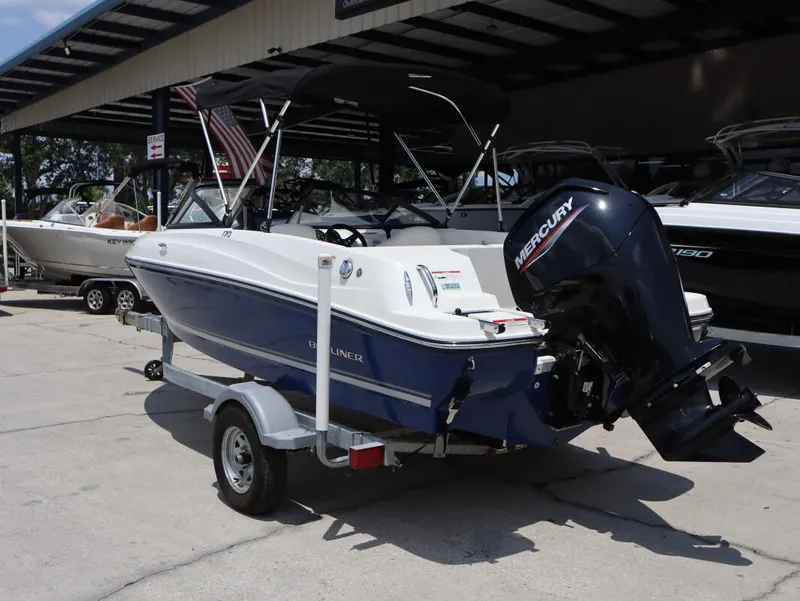Slide: The Image of 2022 Bayliner 170 BR boat with Mercury engine on trailer, parked at a marina. - 3