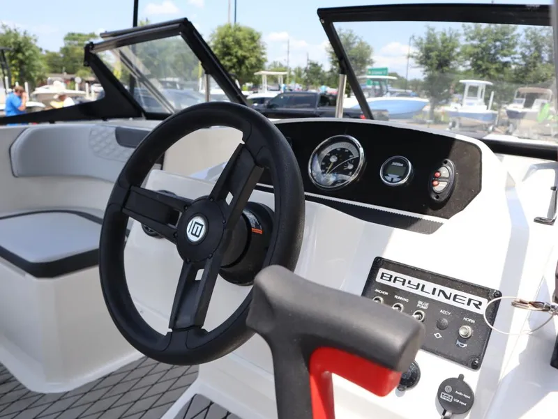 Slide: The Image of 2022 Bayliner 170 BR boat dashboard with steering wheel and control panel. - 8