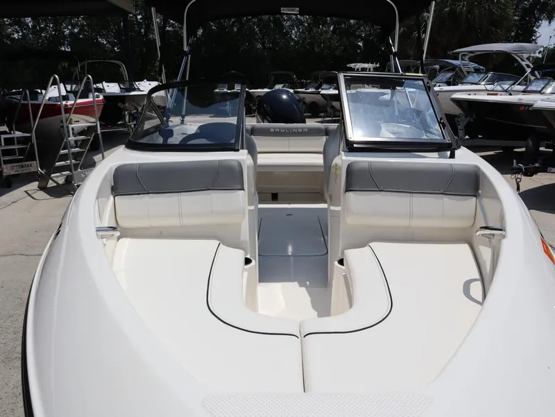 Slide: The Image of 2022 Bayliner 170 BR boat interior with seating and windshield, displayed outdoors. - 9