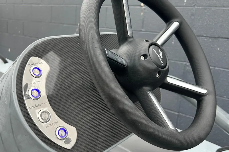 Slide: The Image of Steering wheel of 2024 Highfield Classic 340 FCT boat with control buttons. - 10