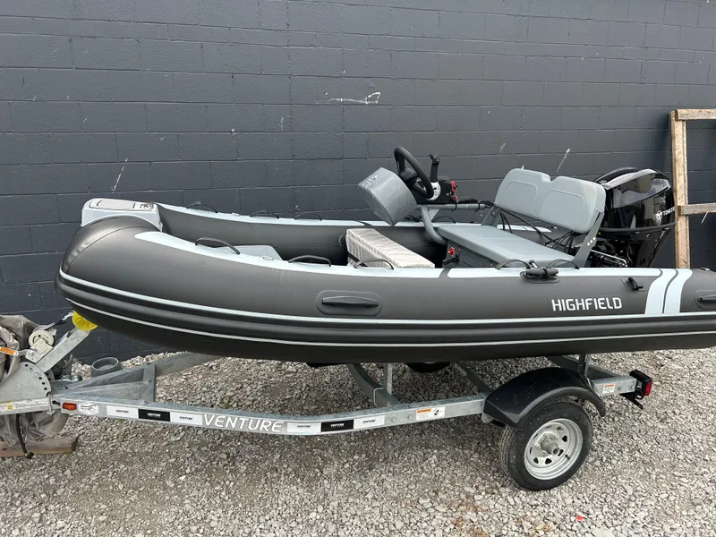 Slide: The Image of 2024 Highfield Classic 340 FCT boat on trailer, gray exterior, parked outdoors. - 5