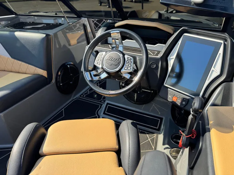 Slide: The Image of 2022 Tigé Z3 boat cockpit with modern steering wheel and touchscreen display. - 16