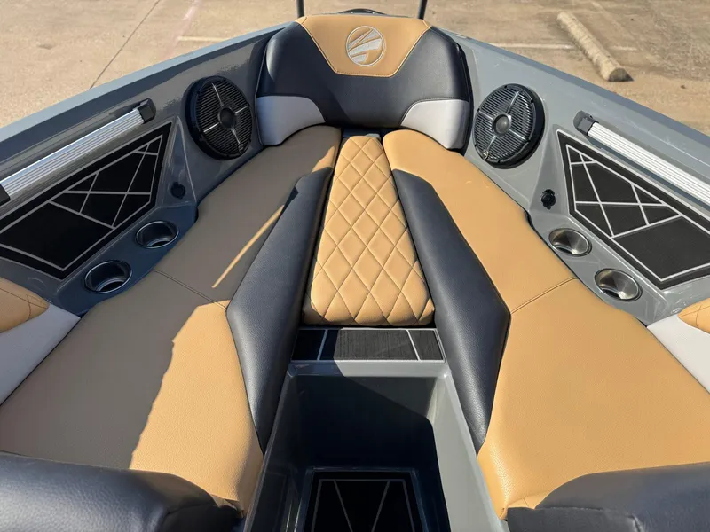 Slide: The Image of 2022 Tigé Z3 boat interior with tan and black seating, cup holders, and speakers. - 17