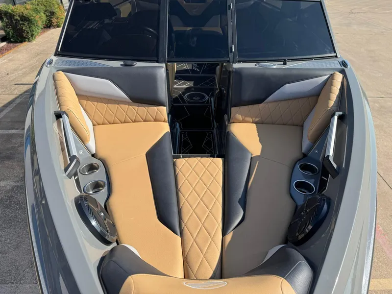 Slide: The Image of 2022 Tigé Z3 boat interior with tan and black seating, cup holders, and speakers. - 18