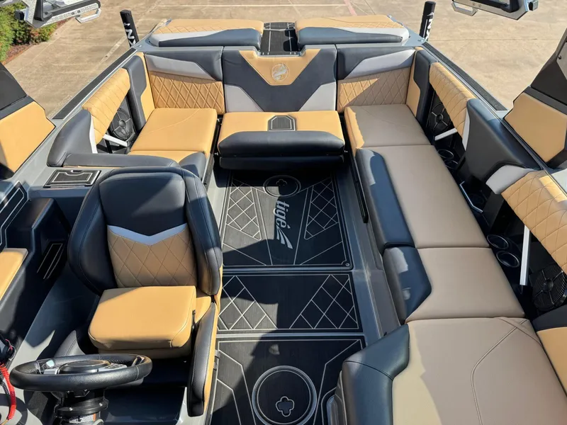 Slide: The Image of 2022 Tigé Z3 boat interior with luxurious tan and black seating, stylish design. - 21
