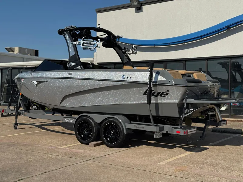 Slide: The Image of 2022 Tigé Z3 boat on trailer, parked outside a building. - 3