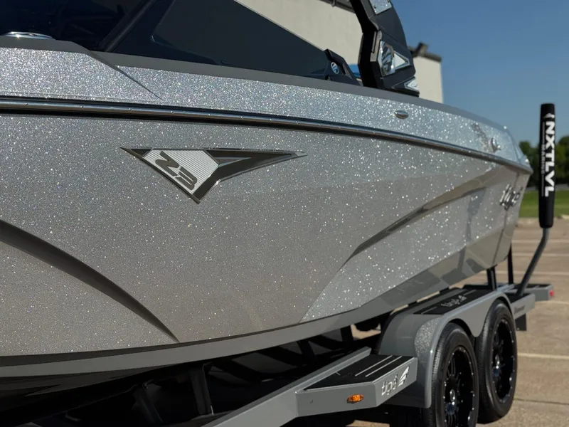 Slide: The Image of 2022 Tigé Z3 boat with sparkling silver finish on a trailer. - 4