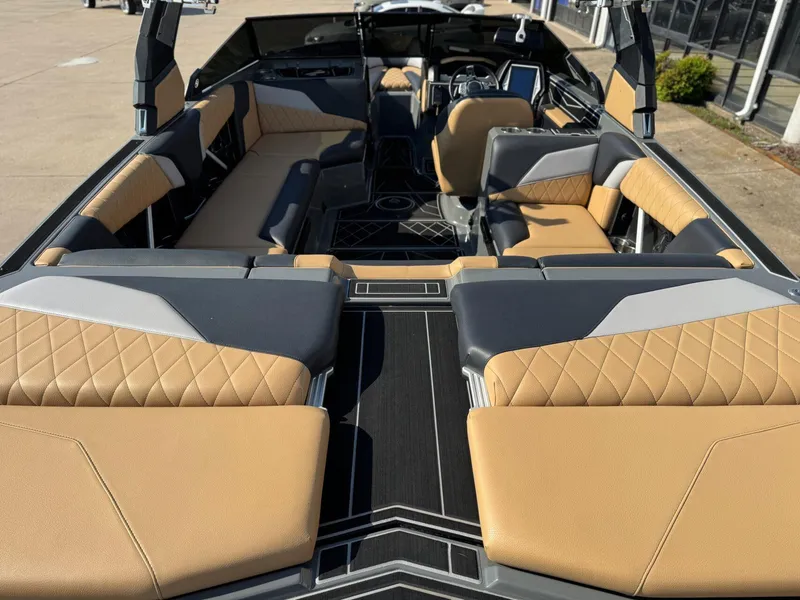Slide: The Image of 2022 Tigé Z3 boat interior with tan and gray seating, featuring modern design and spacious layout. - 9