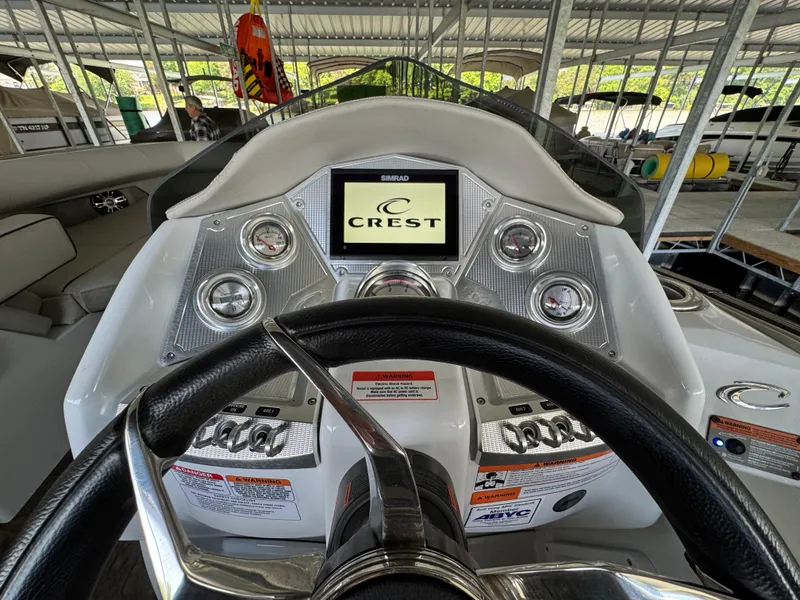 Slide: The Image of 2019 Crest Savannah 250 SLS boat dashboard with steering wheel and control panel. - 11