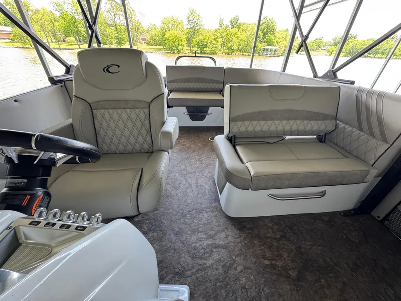 Slide: The Image of 2019 Crest Savannah 250 SLS boat interior with luxurious seating and steering wheel. - 15