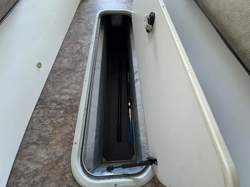 Slide: The Image of 2019 Crest Savannah 250 SLS storage compartment with open hatch, revealing interior space. - 16