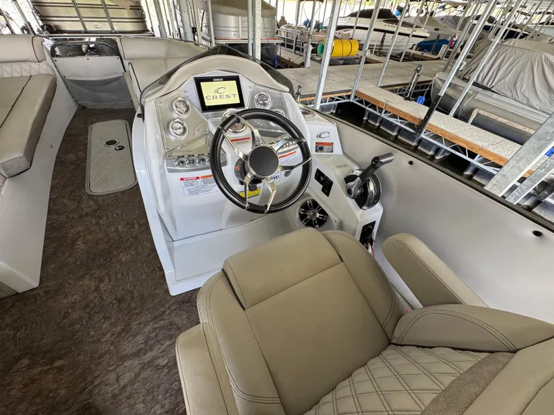 Slide: The Image of 2019 Crest Savannah 250 SLS boat interior with steering wheel and control panel. - 18