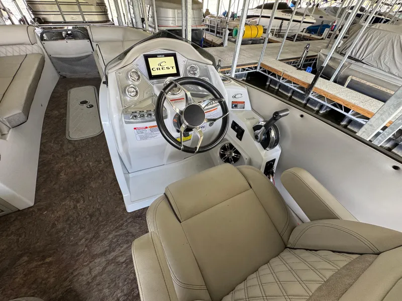 Slide: The Image of 2019 Crest Savannah 250 SLS boat interior with steering wheel and control panel. - 19