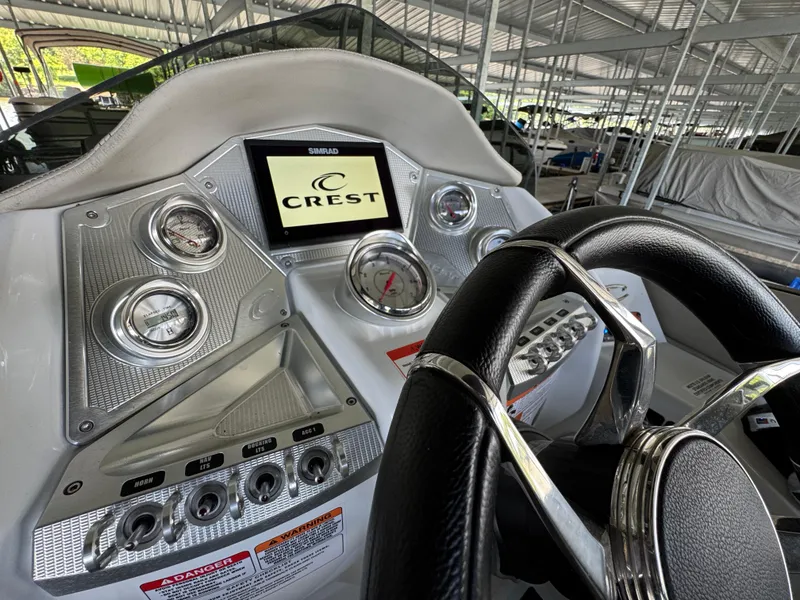 Slide: The Image of 2019 Crest Savannah 250 SLS boat dashboard with steering wheel and control panel. - 20