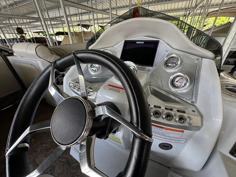 Slide: The Image of 2019 Crest Savannah 250 SLS boat dashboard with steering wheel and control panel. - 26