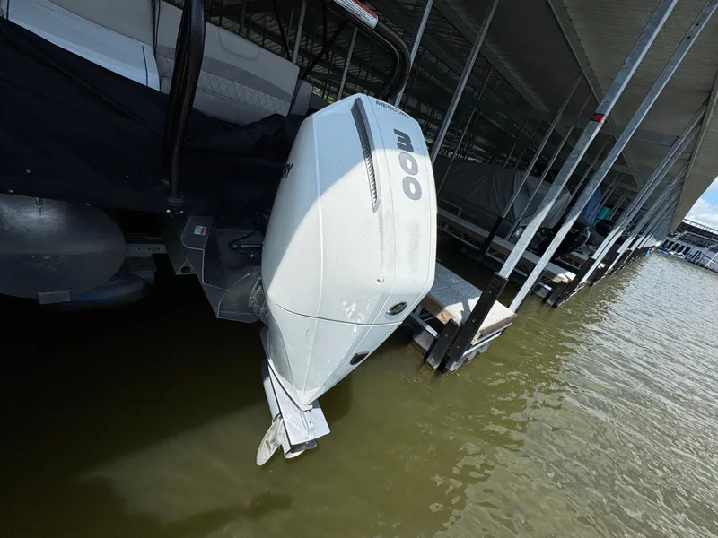 Slide: The Image of 2019 Crest Savannah 250 SLS boat with outboard motor docked on water. - 28
