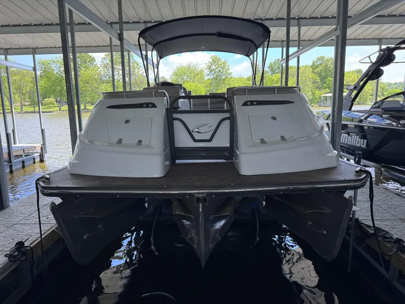 Slide: The Image of 2019 Crest Savannah 250 SLS pontoon boat docked under a covered marina. - 3