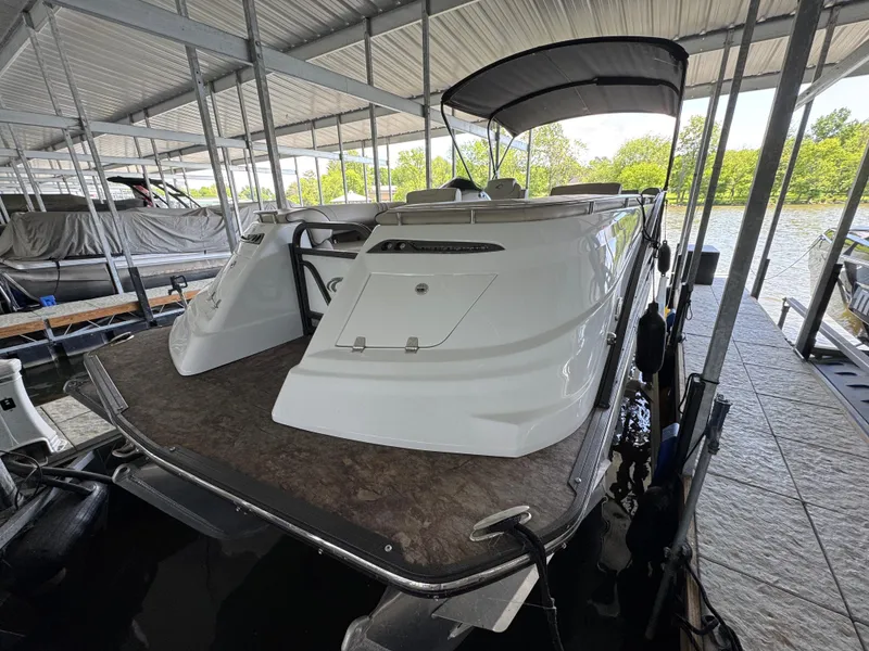 Slide: The Image of 2019 Crest Savannah 250 SLS pontoon boat docked under a covered marina. - 5
