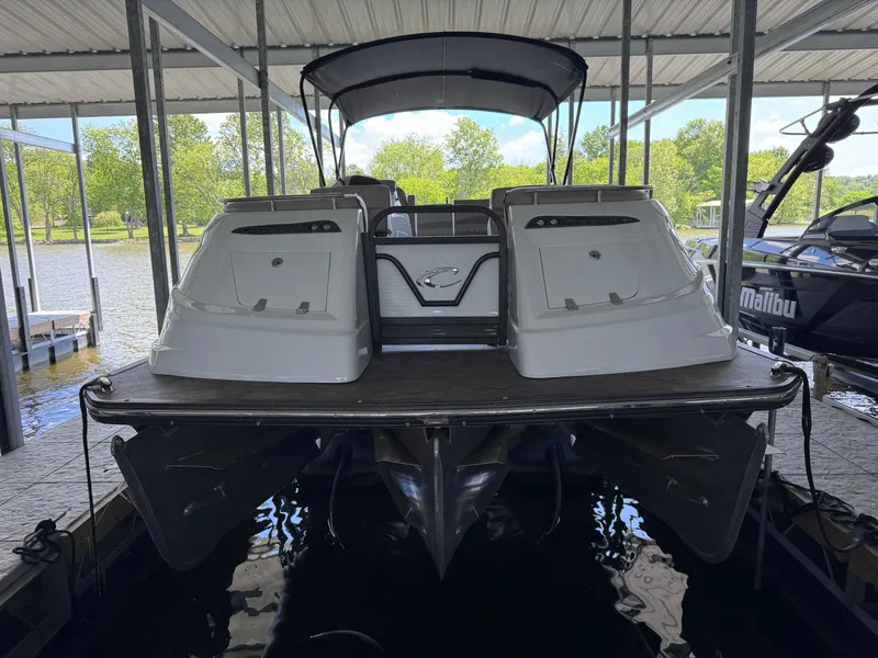 Slide: The Image of 2019 Crest Savannah 250 SLS pontoon boat docked under a covered marina. - 9