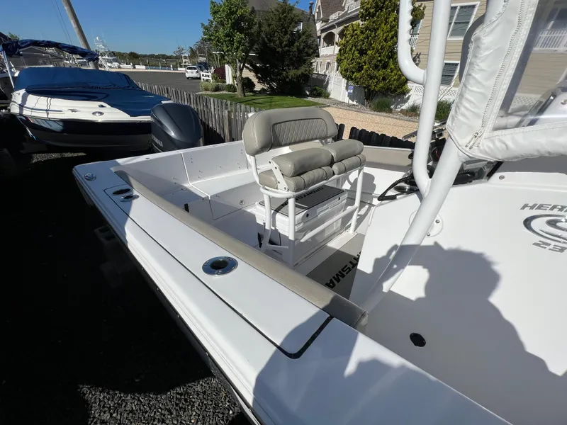 Slide: The Image of 2021 Sportsman Heritage 231 Center Console boat with seating, docked outdoors. - 15
