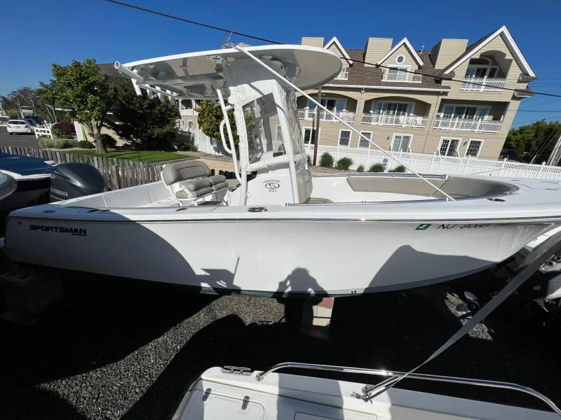Slide: The Image of 2021 Sportsman Heritage 231 Center Console boat parked outdoors near residential buildings. - 16