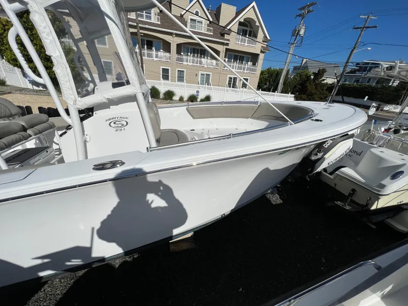 Slide: The Image of 2021 Sportsman Heritage 231 Center Console boat docked near residential area. - 17