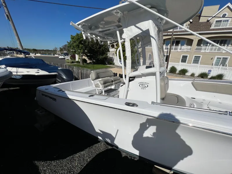 Slide: The Image of 2021 Sportsman Heritage 231 Center Console boat parked outdoors on gravel. - 18