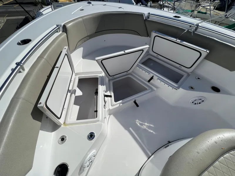 Slide: The Image of 2021 Sportsman Heritage 231 Center Console boat with open storage compartments. - 26
