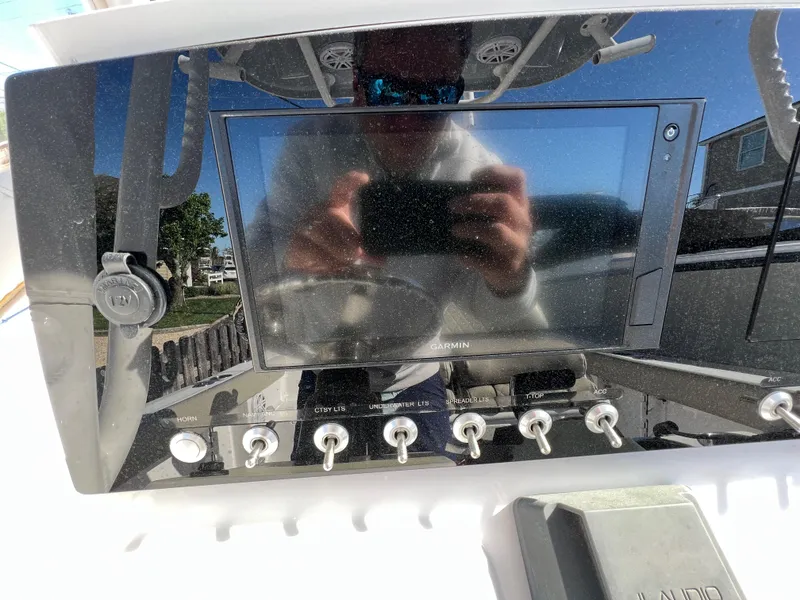 Slide: The Image of 2021 Sportsman Heritage 231 Center Console dashboard with control panel and display screen. - 36