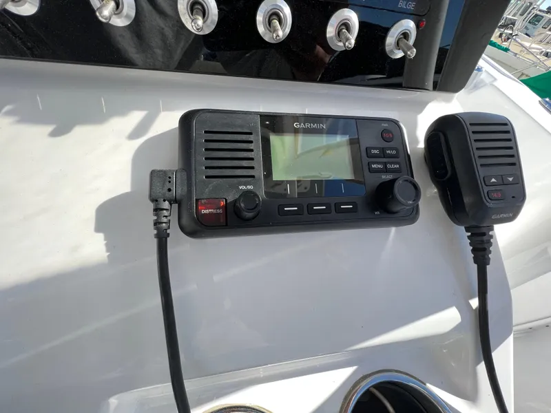 Slide: The Image of Garmin marine radio on 2021 Sportsman Heritage 231 Center Console boat dashboard. - 38