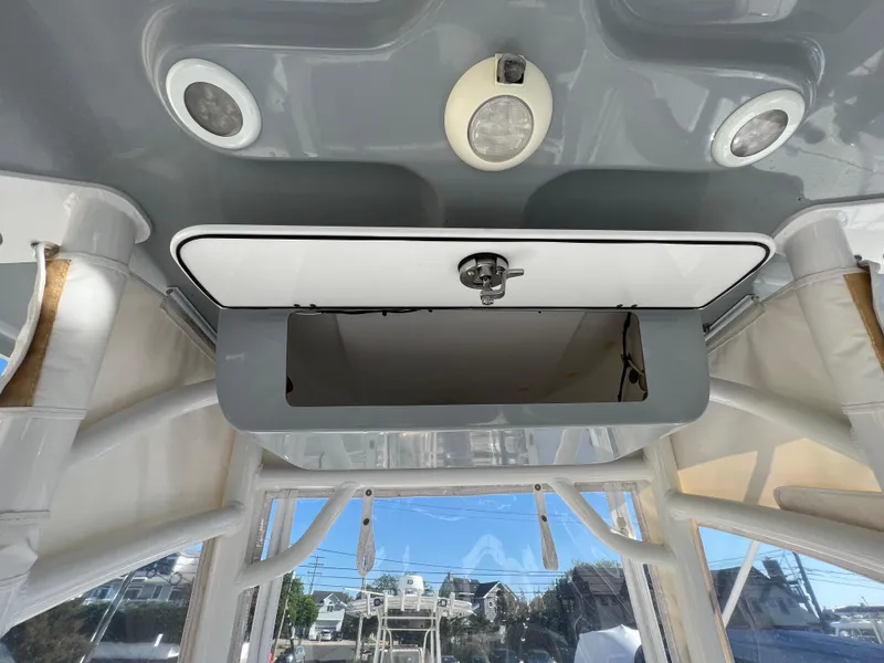 Slide: The Image of 2021 Sportsman Heritage 231 Center Console interior with open storage compartment and ceiling lights. - 39
