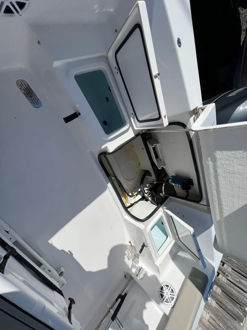 Slide: The Image of 2021 Sportsman Heritage 231 Center Console boat interior with open storage compartments. - 40