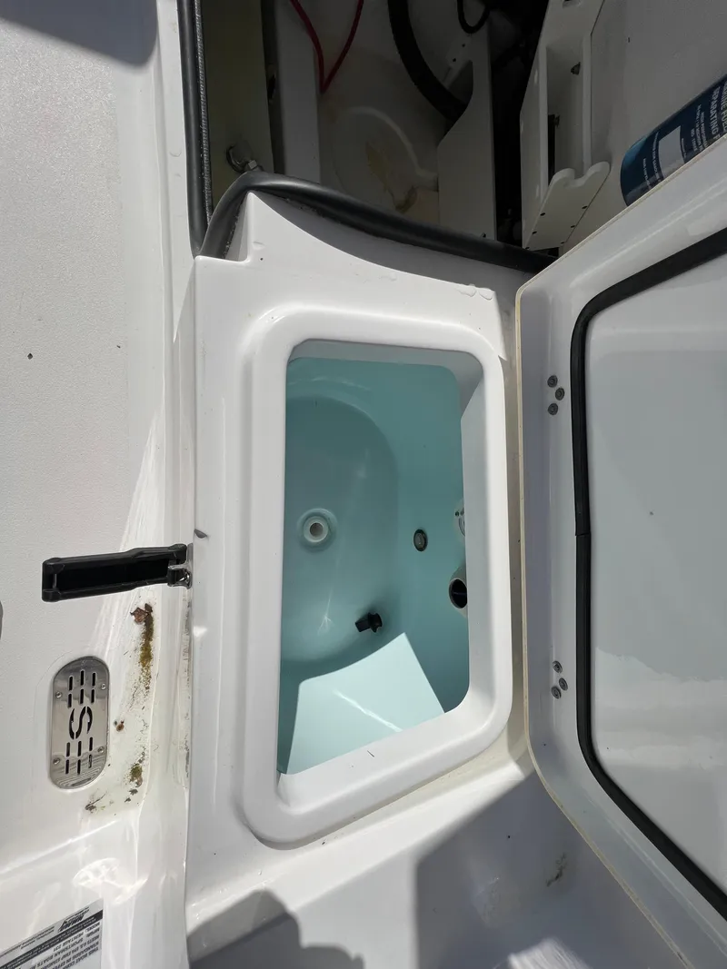 Slide: The Image of 2021 Sportsman Heritage 231 Center Console livewell with open lid, showcasing interior design. - 42