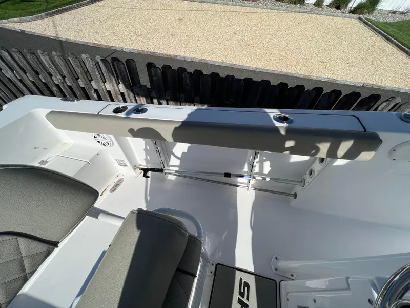 Slide: The Image of 2021 Sportsman Heritage 231 Center Console boat interior with seating and rod holders. - 47