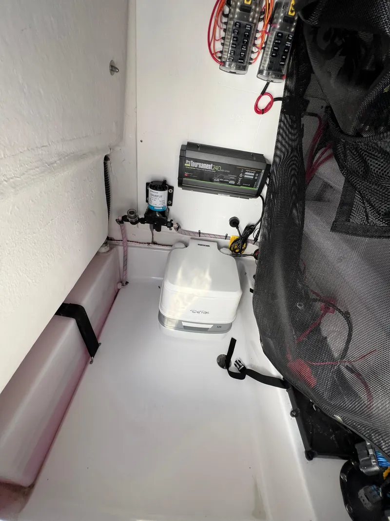 Slide: The Image of 2021 Sportsman Heritage 231 Center Console interior wiring and storage compartment. - 49