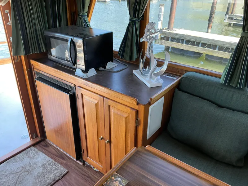 Slide: The Image of Interior of 1978 Californian 34 LRC boat with microwave, wooden cabinets, and decorative anchor. - 10