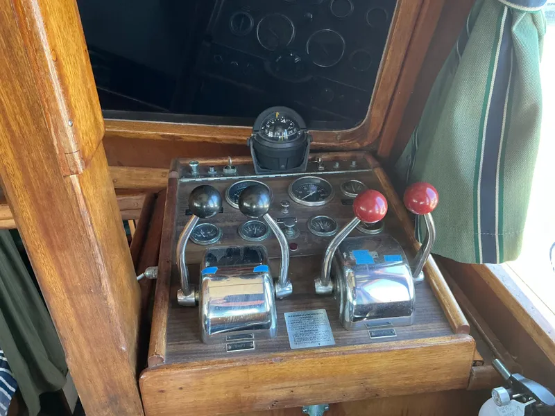 Slide: The Image of 1978 Californian 34 LRC boat control panel with levers and compass. - 14