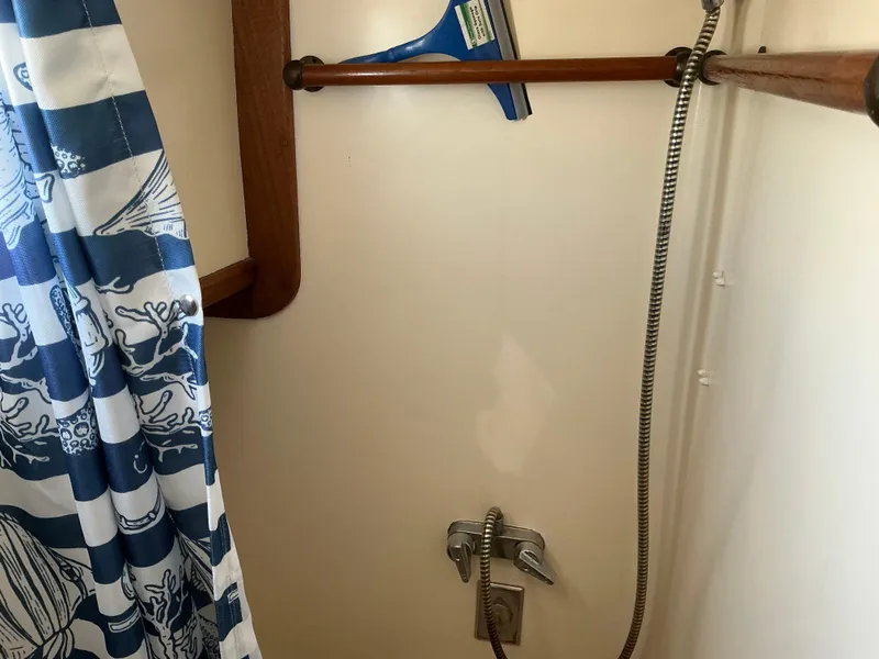 Slide: The Image of 1978 Californian 34 LRC boat shower with nautical curtain and wooden accents. - 16