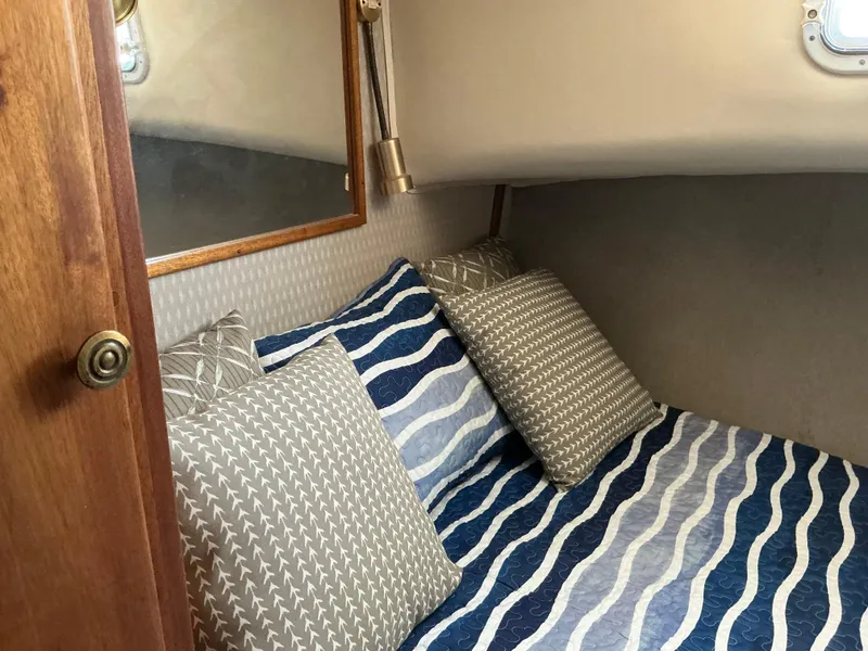 Slide: The Image of Cozy cabin interior of 1978 Californian 34 LRC with patterned bedding and pillows. - 20