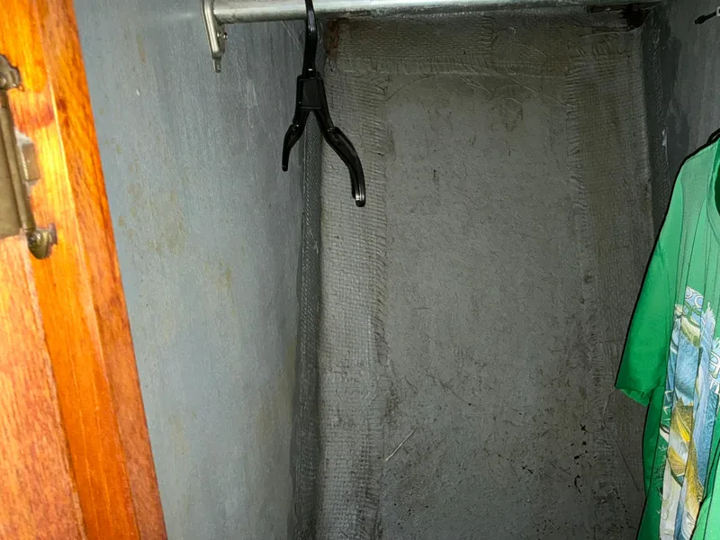 Slide: The Image of Small closet with a single hanger and a green shirt, aboard a 1978 Californian 34 LRC. - 22