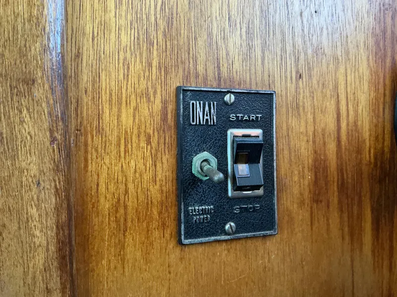 Slide: The Image of Onan electric switch on 1978 Californian 34 LRC wooden panel. - 26
