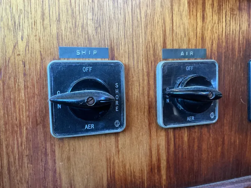 Slide: The Image of 1978 Californian 34 LRC control switches on wooden panel. - 27