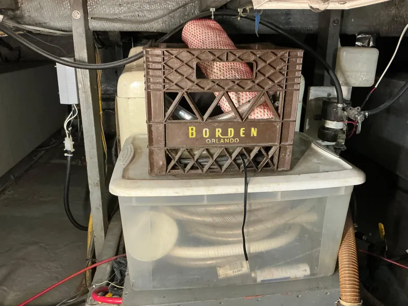 Slide: The Image of 1978 Californian 34 LRC engine room with storage crate and hoses. - 33